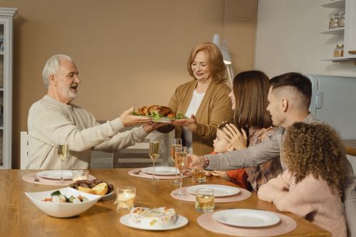 Free A family shares a joyful Thanksgiving dinner together at home. Stock Photo