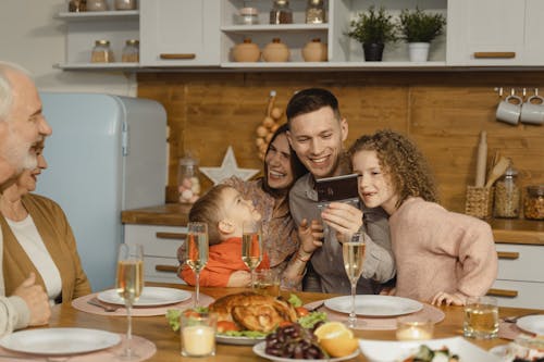 Free A Happy Family Bonding Time Sitting on a Dining Table Stock Photo