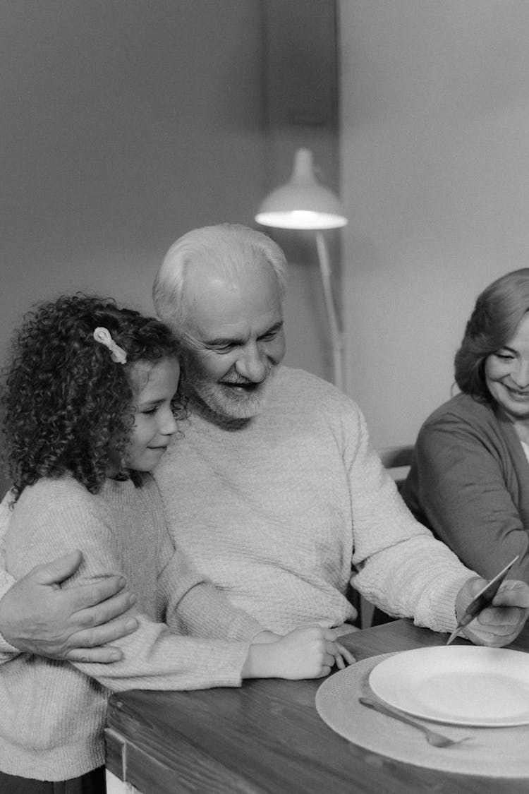 Elderly Man And Young Girl Wearing Sweater