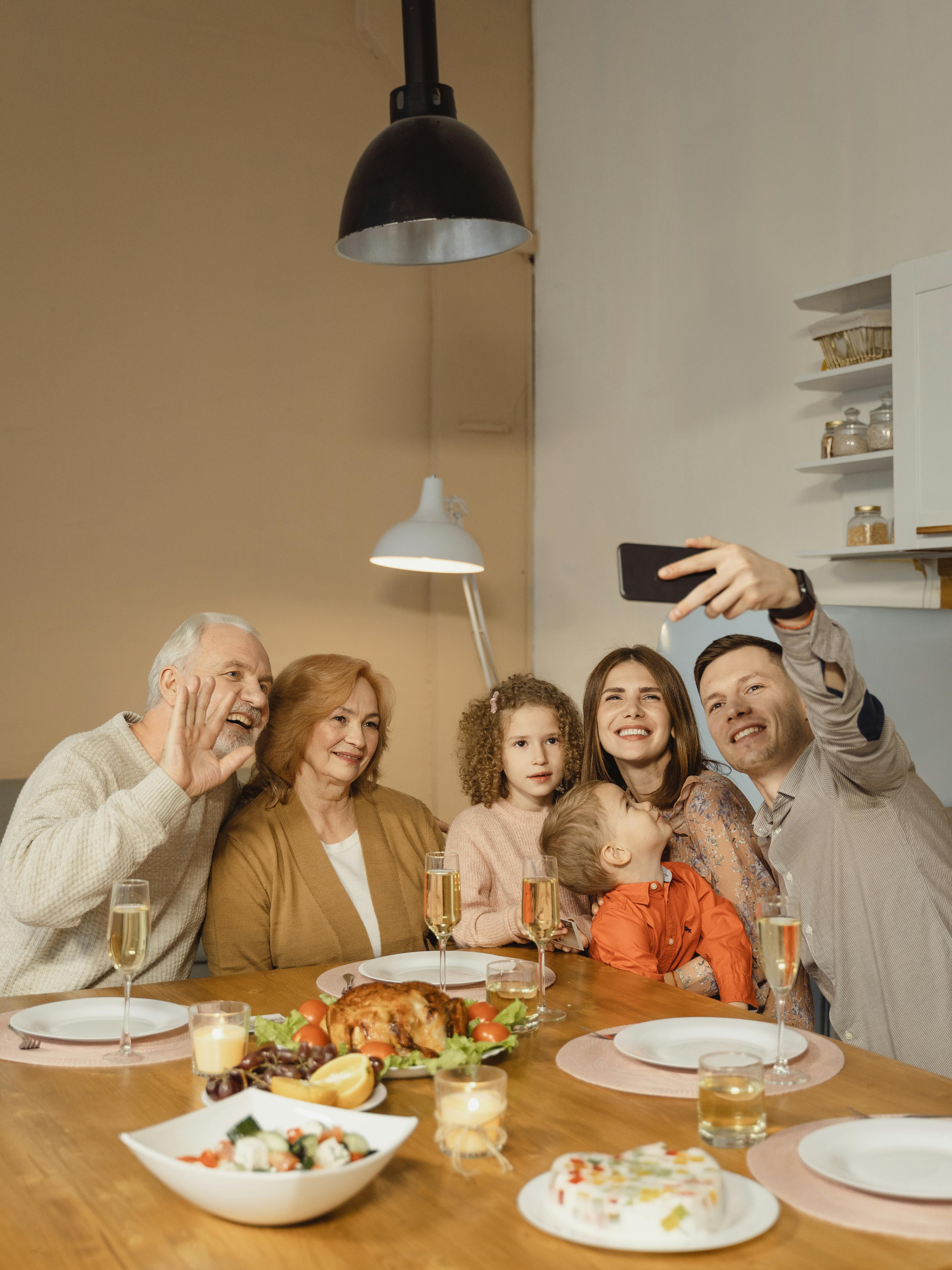 a family smiling and posing while taking a picture