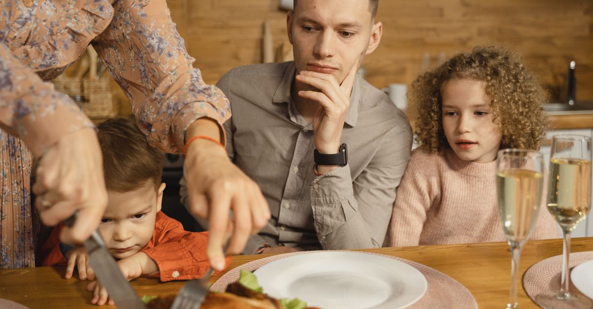 A family gathered around a festive dinner table sharing a holiday meal