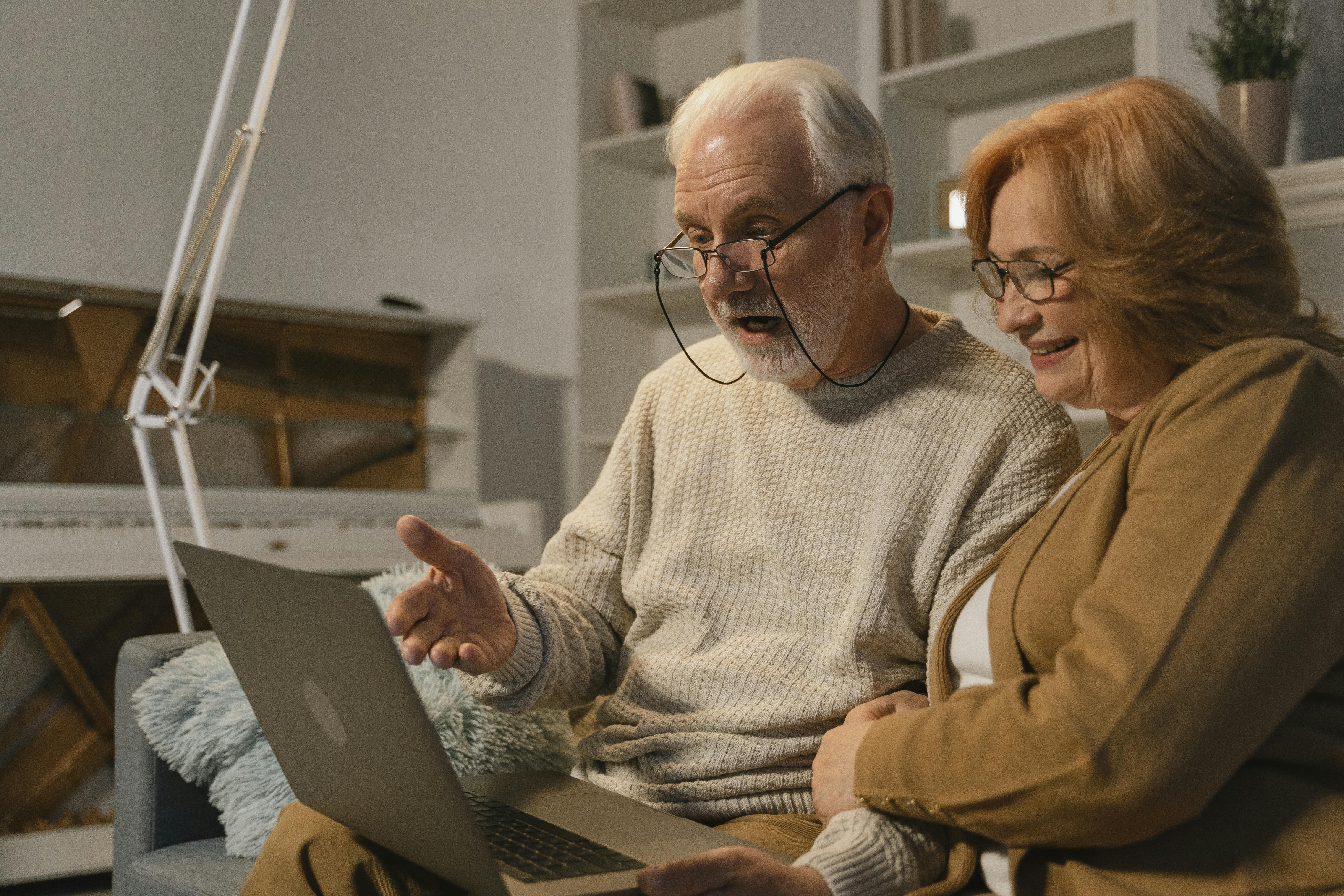 a couple looking at the laptop