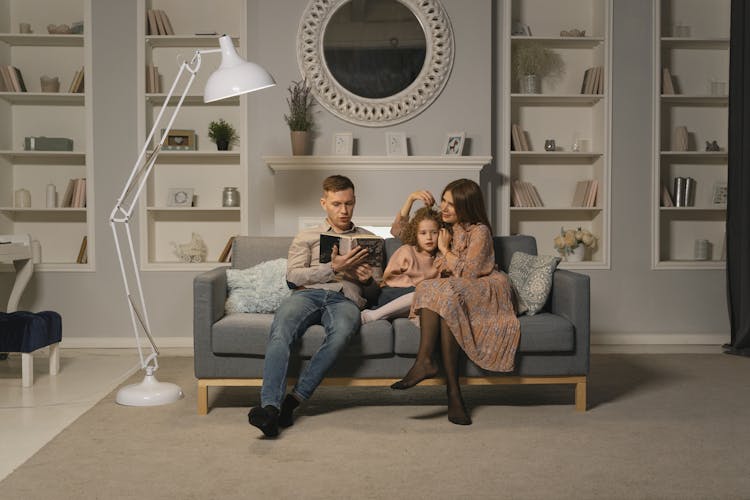 A Family Sitting On The Couch