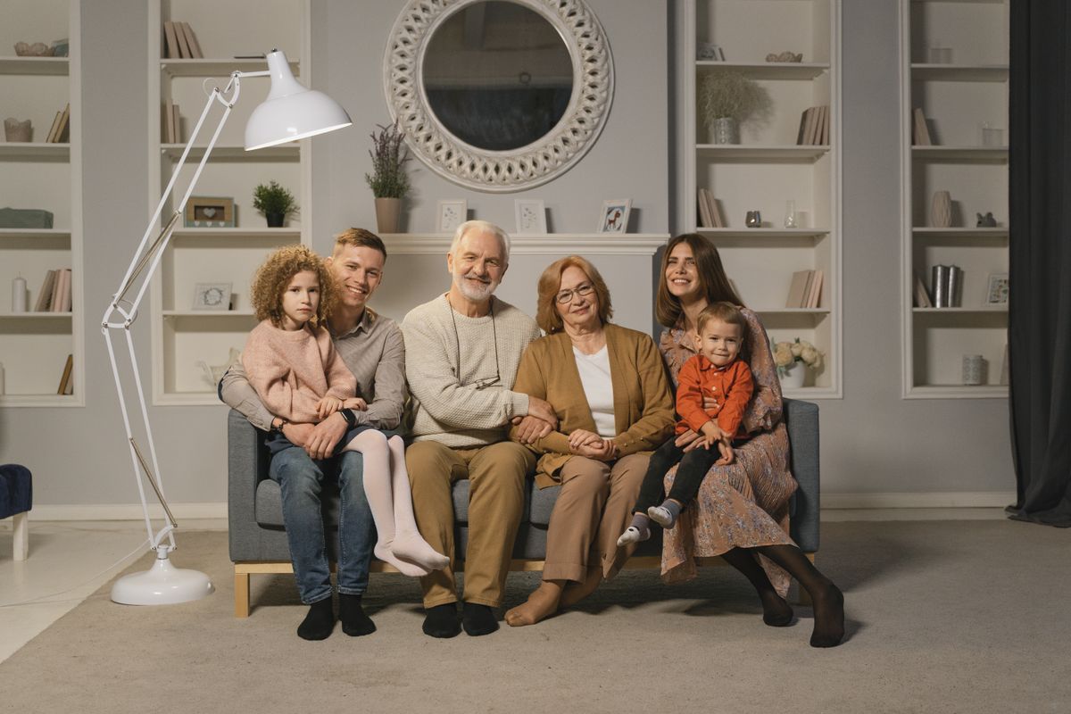 Multigenerational family embracing and smiling together outdoors
