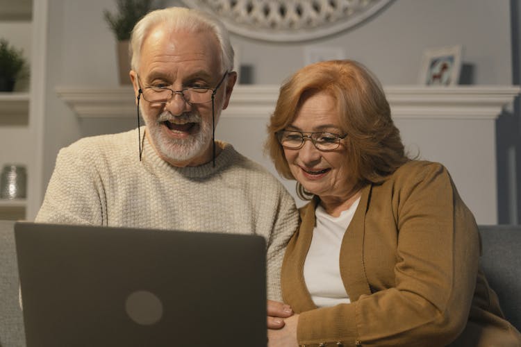 Man And Woman Using A Laptop Computer