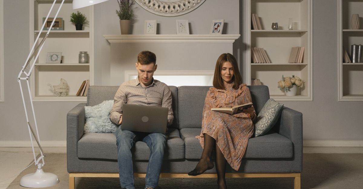 Two people reviewing hotel booking details on a laptop