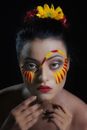 Woman With Red and Yellow Face Paint