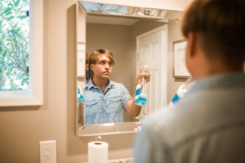 Man Spraying a Mirror