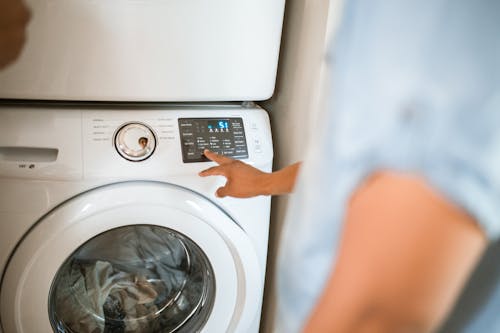 Free Person Using Washing Machine Stock Photo