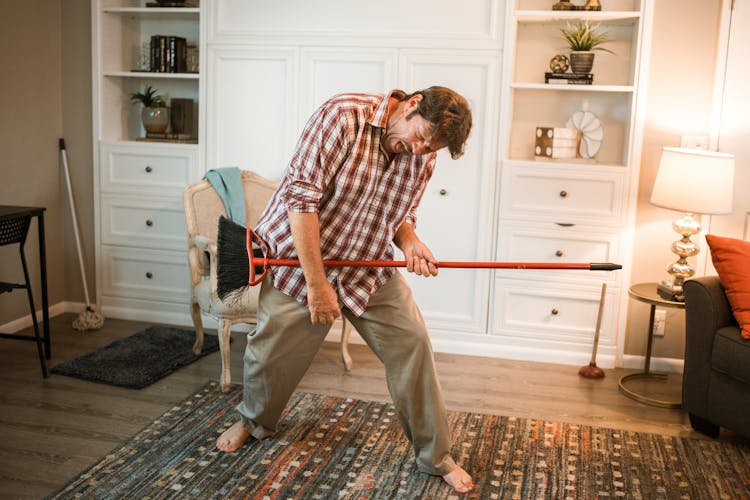 Man Having Fun While Holding A Broom