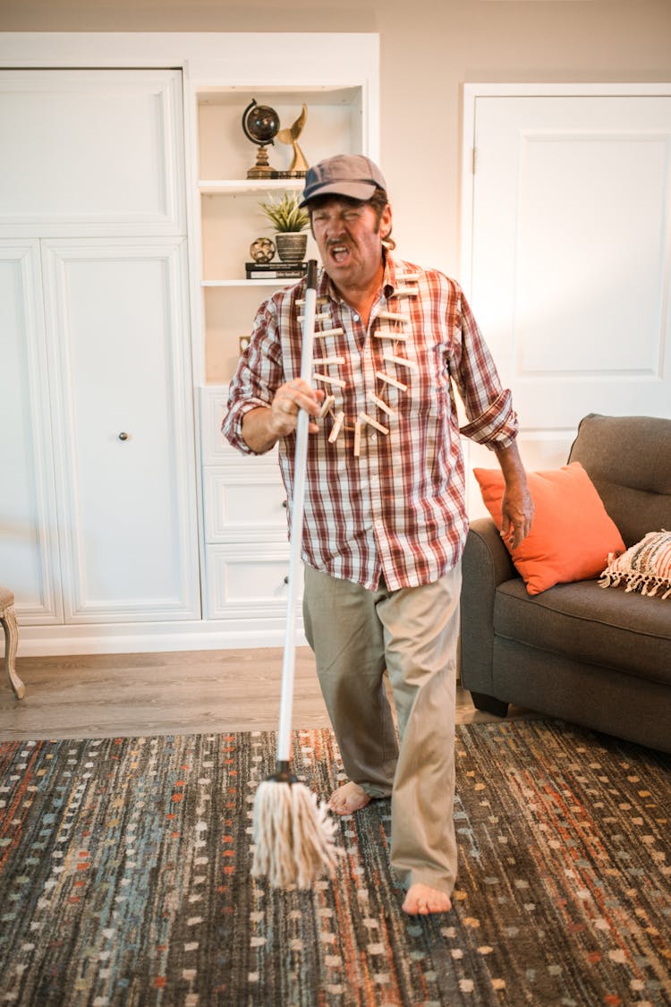 Man Singing While Holding A Mop