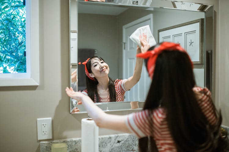 Woman Wiping The Mirror