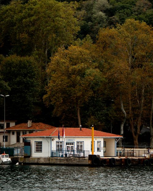 Free Picturesque autumn view of a waterfront building with orange roof in Istanbul, Turkey. Stock Photo
