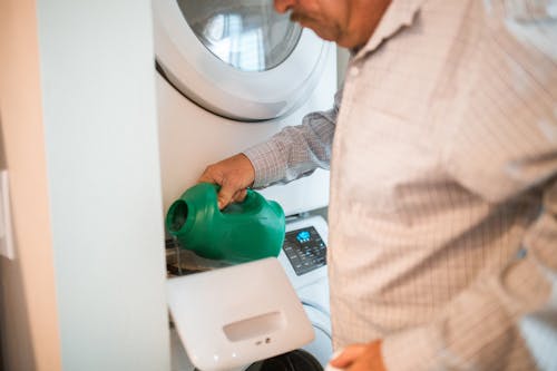 Free 
A Man Pouring Detergent in a Washing Machine Stock Photo