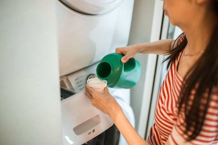 
A Woman Pouring Detergent