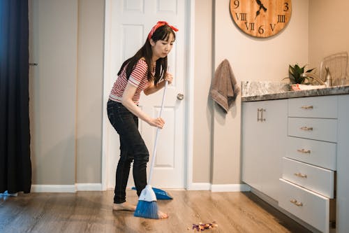 Free 
A Woman Sweeping the Floor Stock Photo