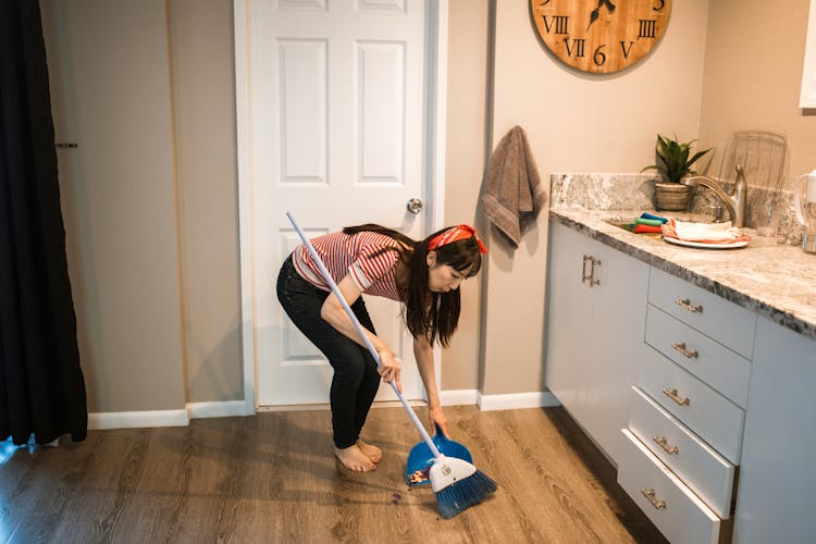 A Woman Sweeping The Floor