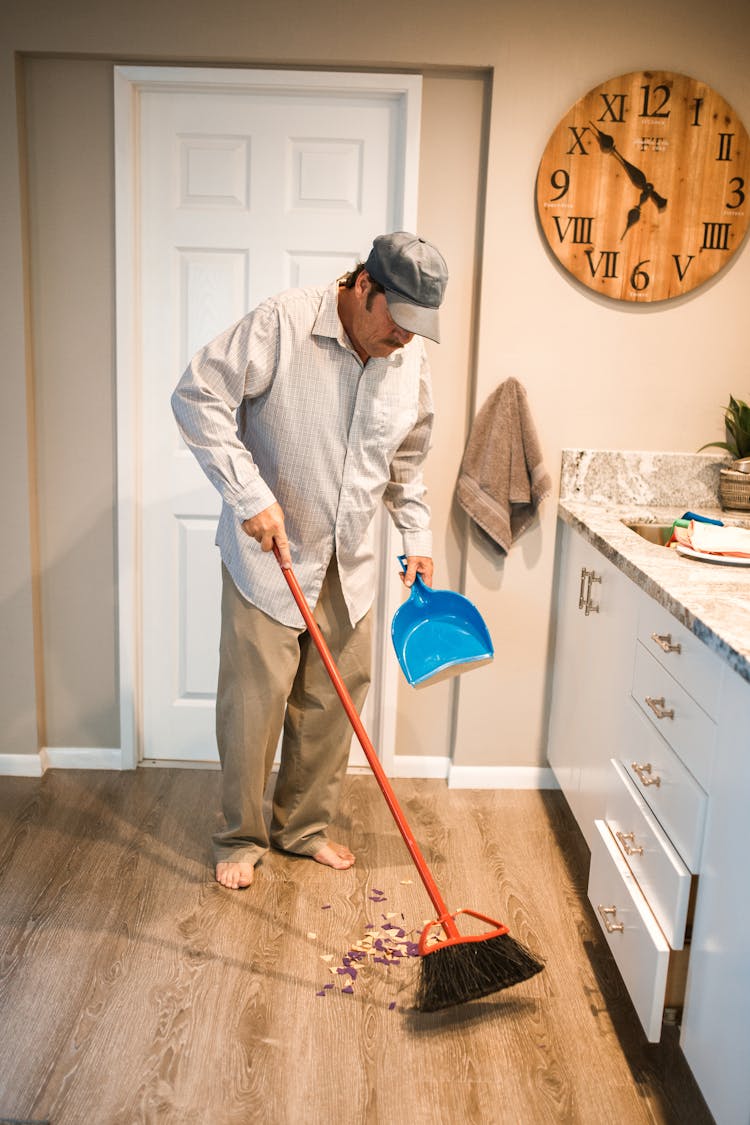 Man Sweeping The Floor