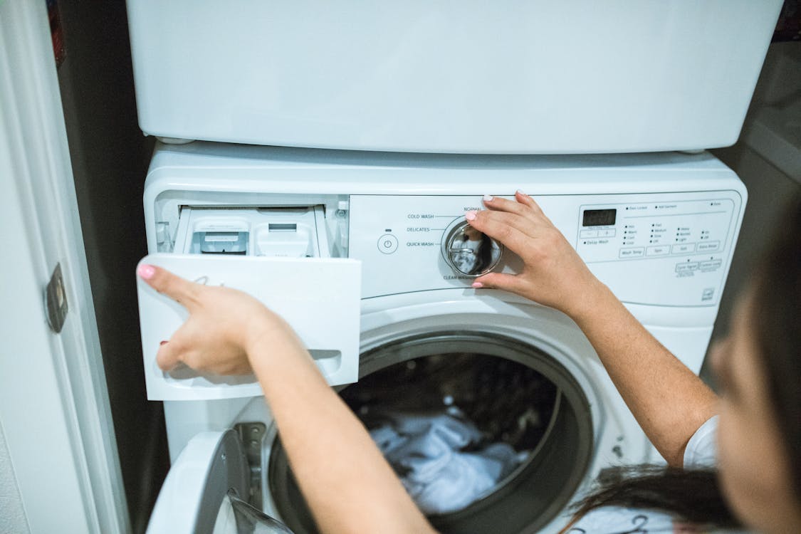 Free Person Holding White Front Load Washing Machine Stock Photo
