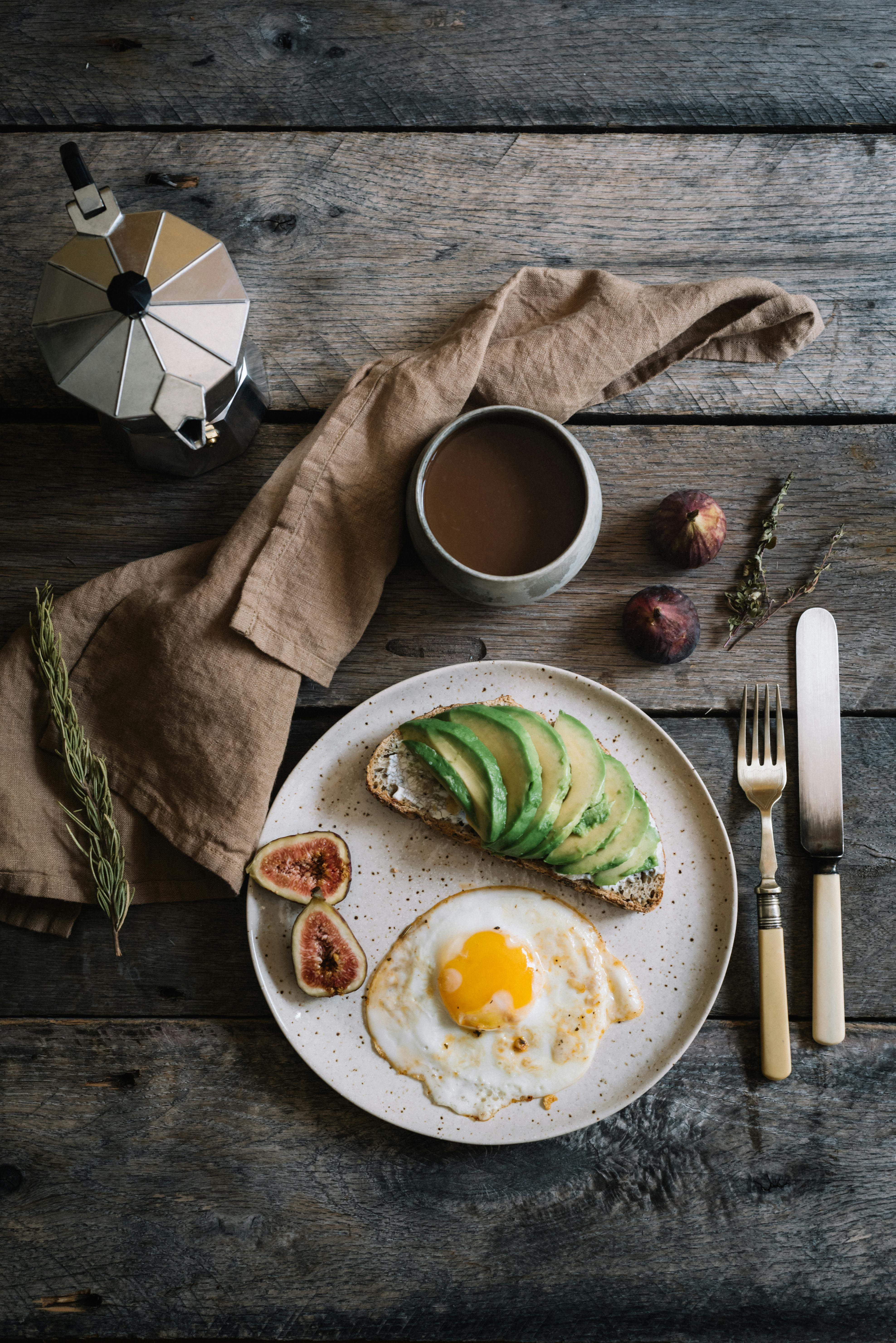 wooden table with delicious breakfast and coffee