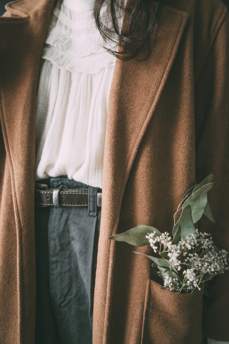 Crop Woman With Flowers In Pocket