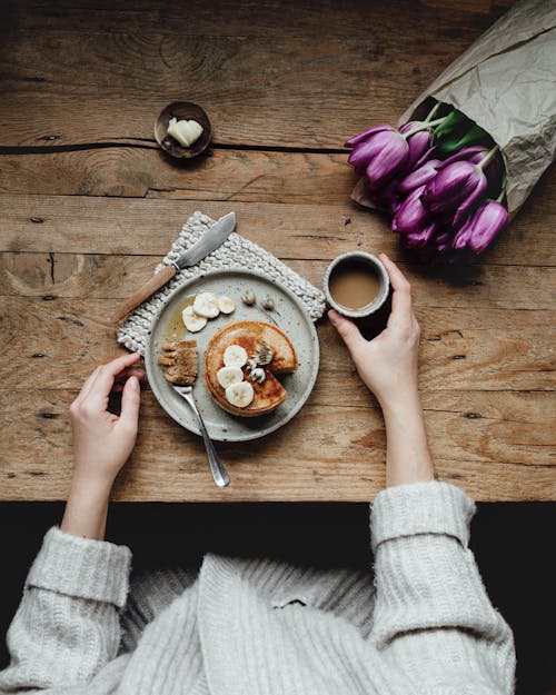 Free Crop woman with coffee and pancakes Stock Photo