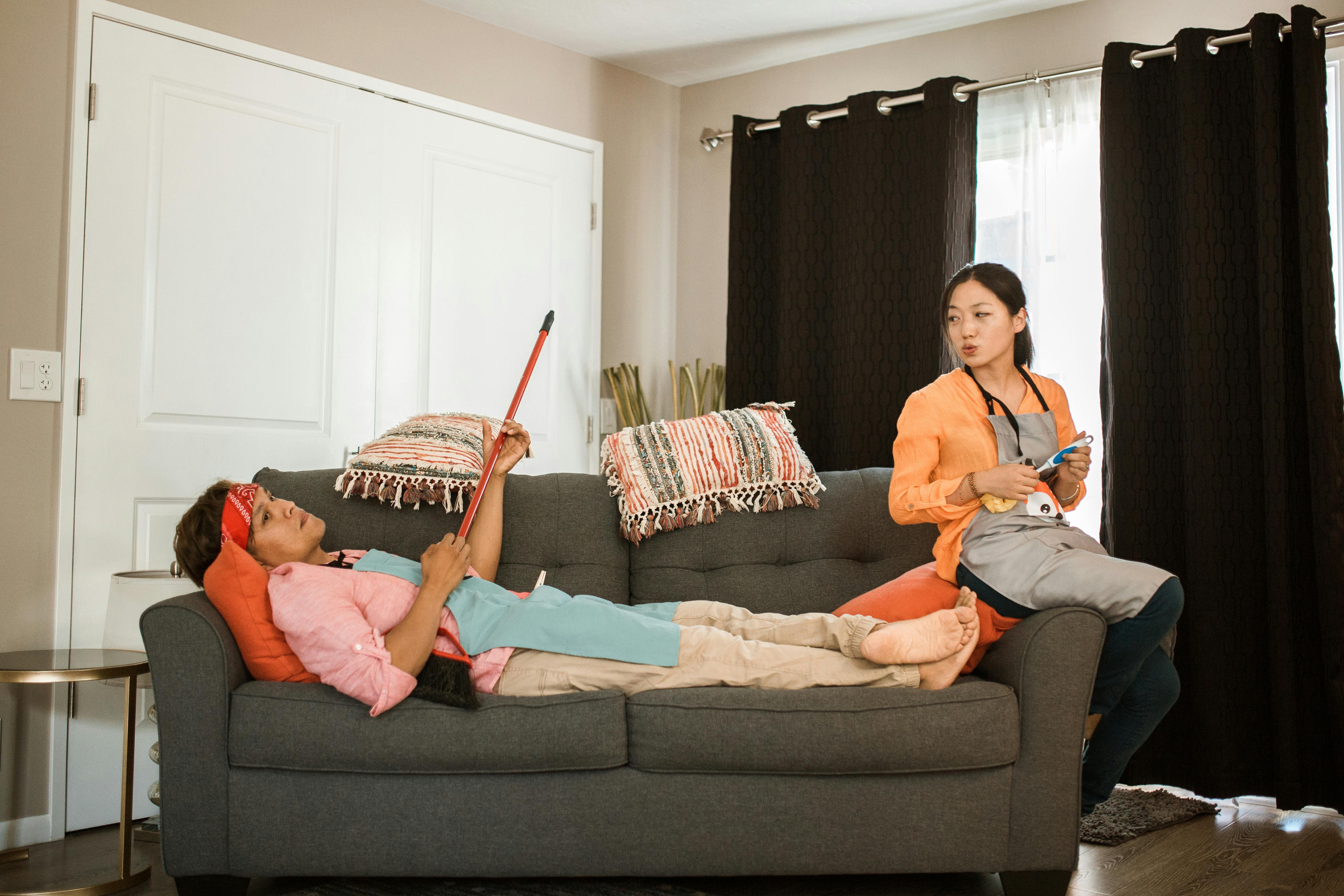 woman in orange shirt sitting on couch