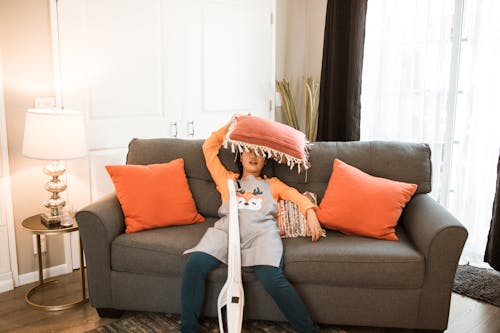 Free A Woman Sitting on a Couch Resting Stock Photo