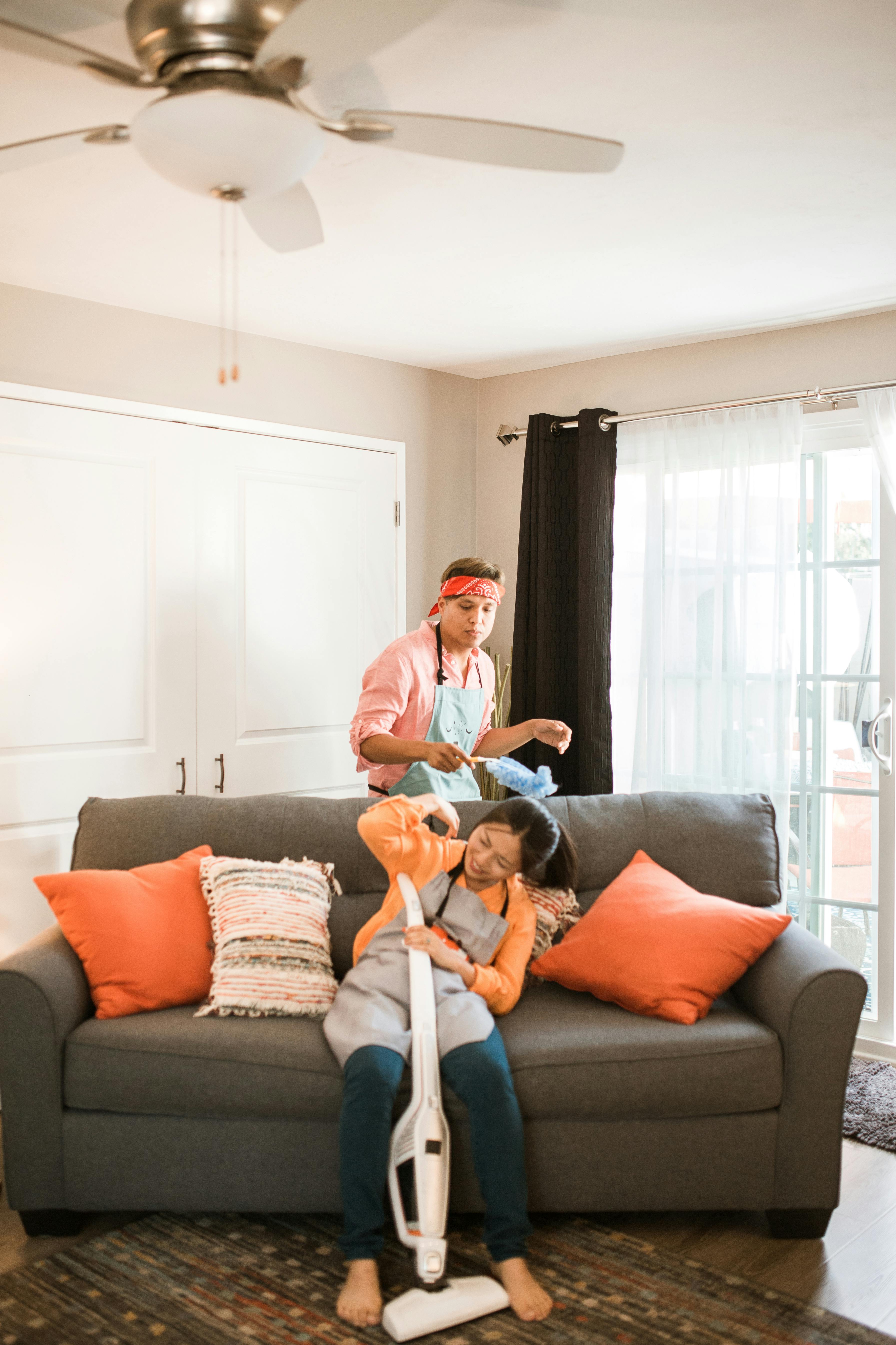 woman in pink long sleeve shirt sitting on gray couch