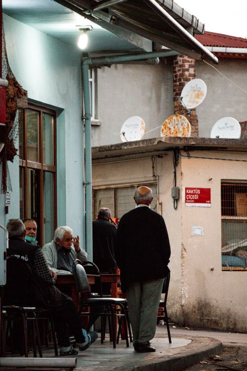 Free Elderly men gather at an outdoor cafe in Istanbul, enjoying leisure time together. Stock Photo