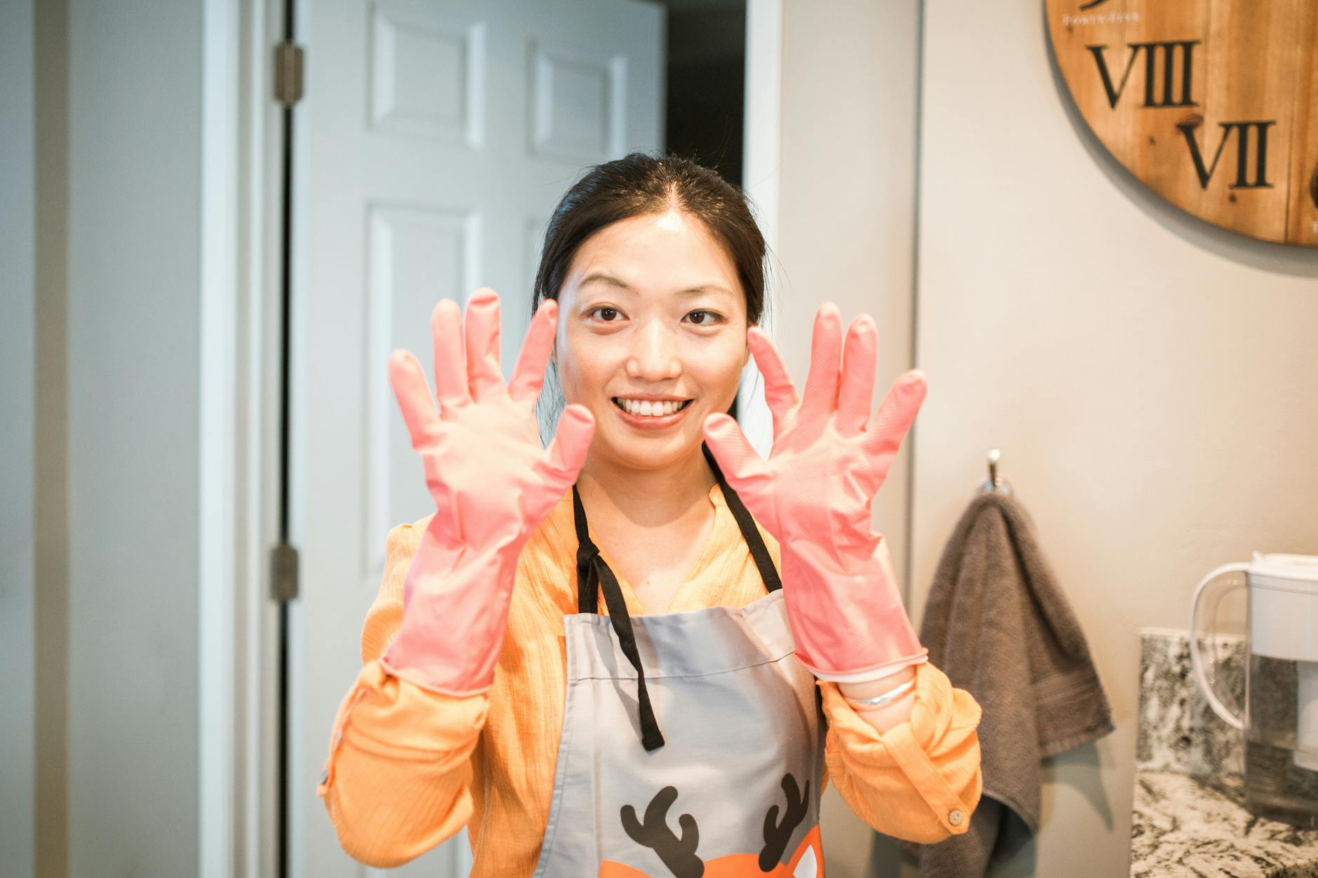 Woman Wearing Pink Latex Gloves and Gray Apron