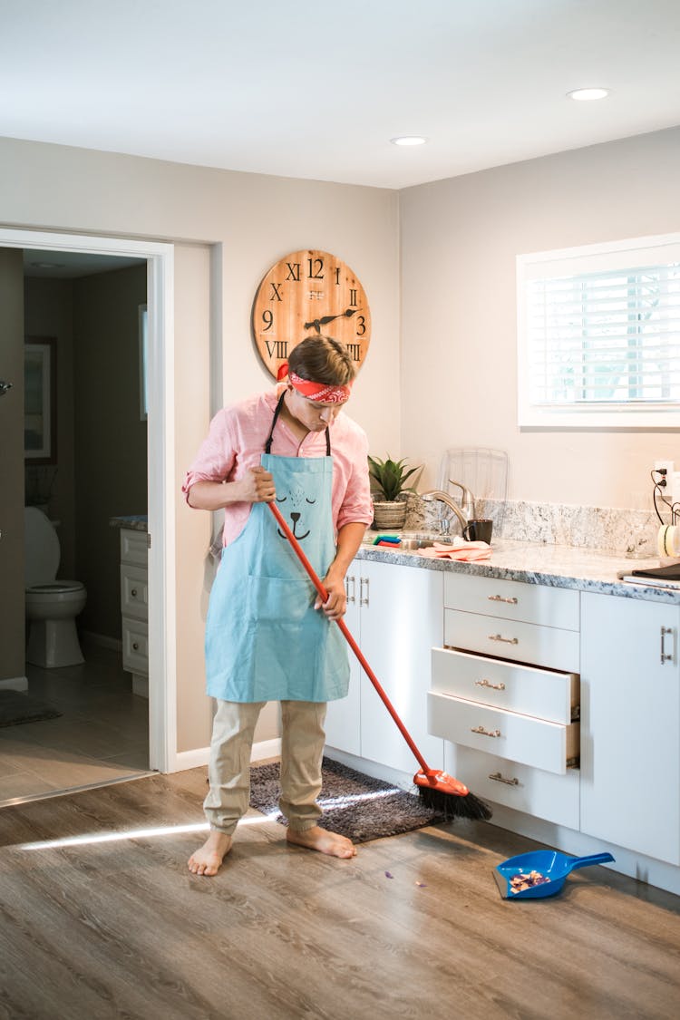 A Man Sweeping On The Floor