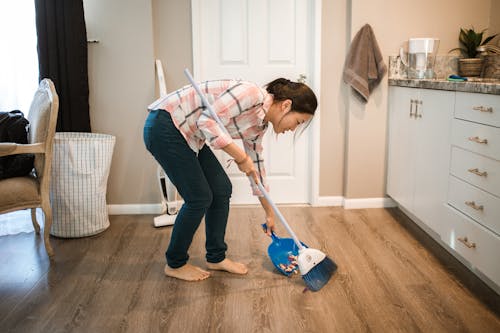 Free A Woman Sweeping the Floor Stock Photo