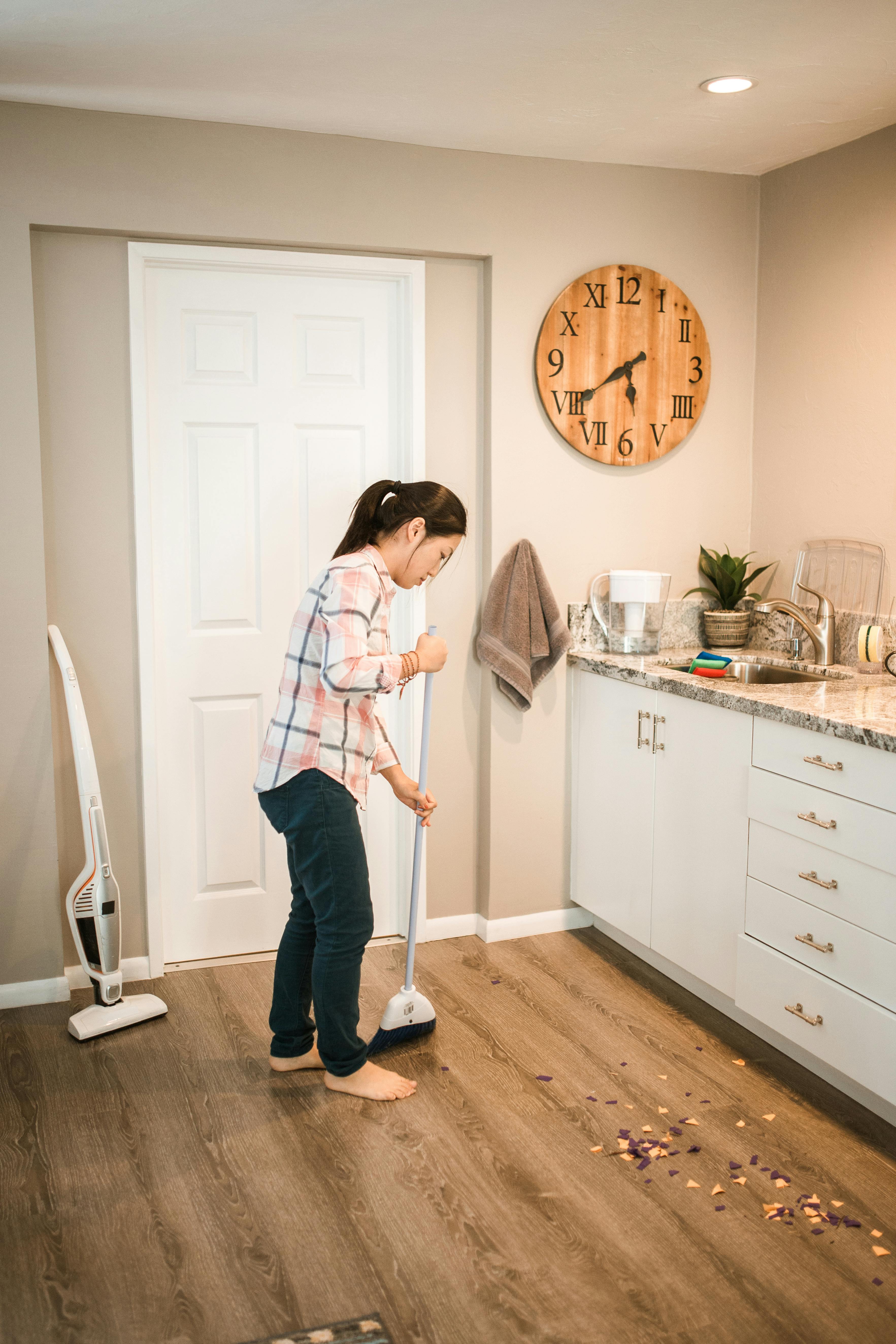 woman in white and blue long sleeve shirt standing beside white wooden door