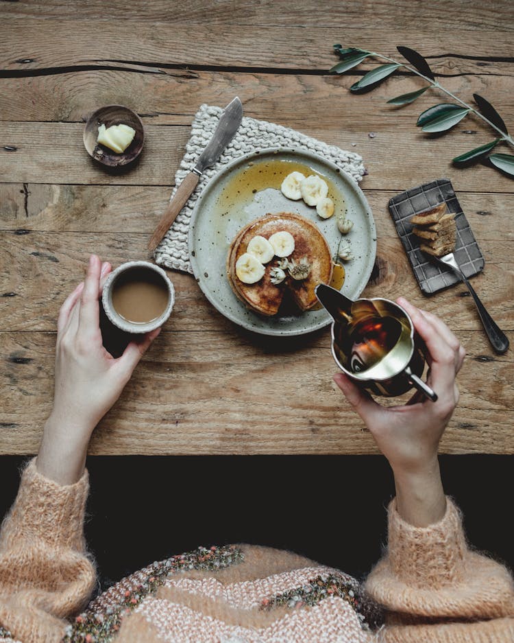 Crop Woman Pouring Sauce On Pancakes