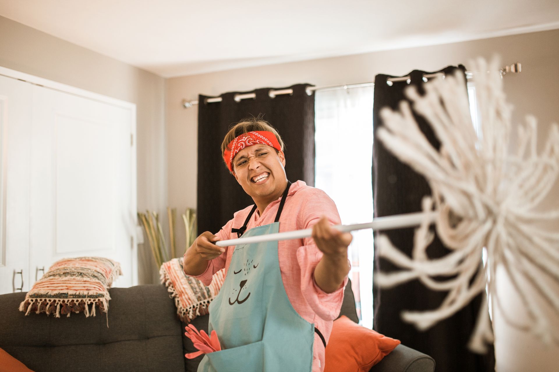 Man Holding a Mop