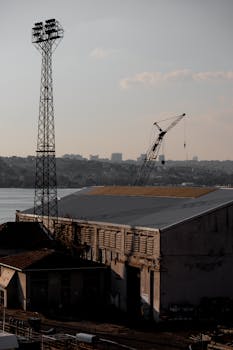 A construction site with a crane, building, and water view in Istanbul, Turkey.