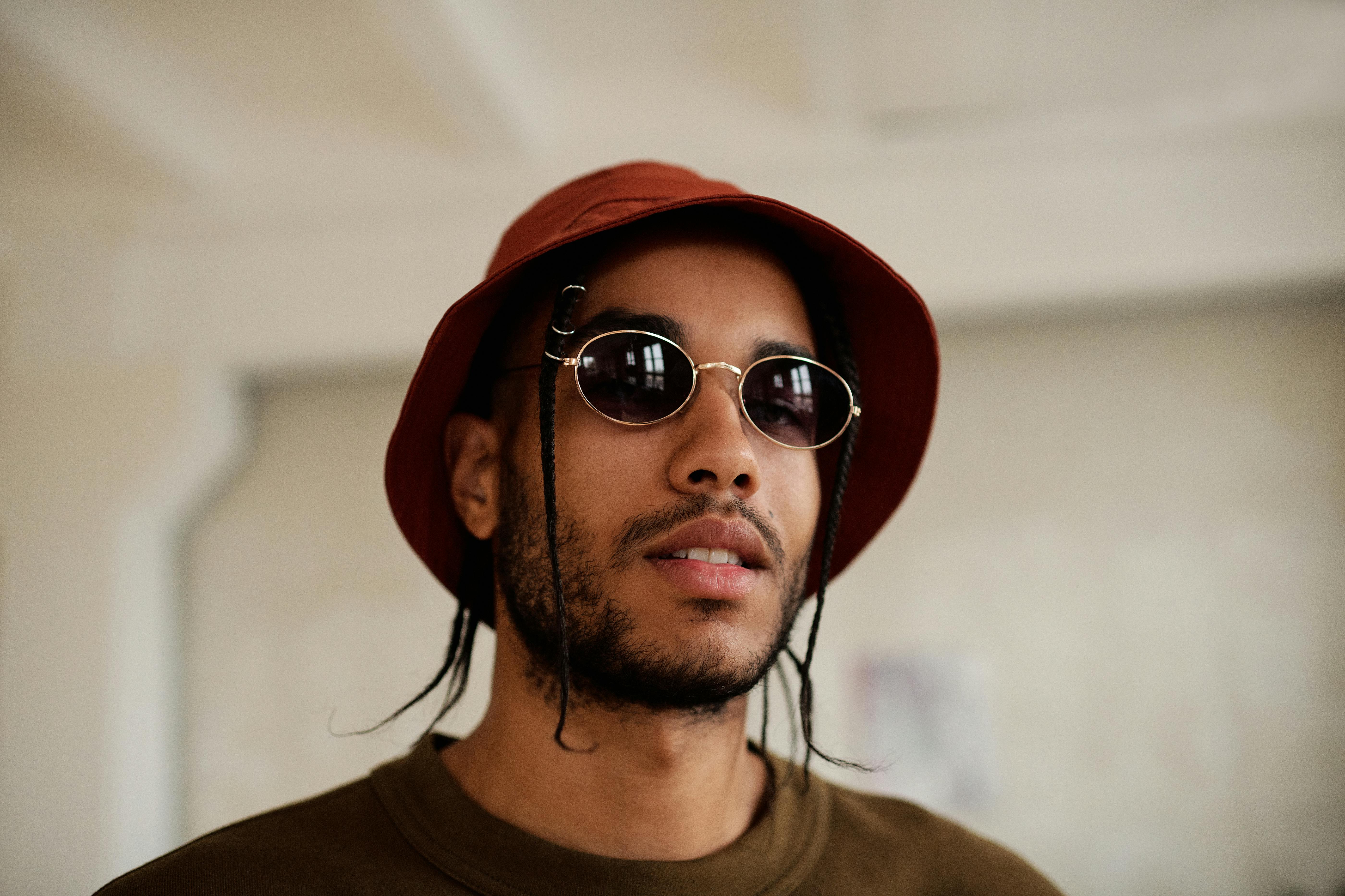 A Man Wearing Sunglasses and a Bucket Hat · Free Stock Photo