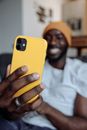 Woman in White Long Sleeve Shirt Holding Yellow Iphone 5 C