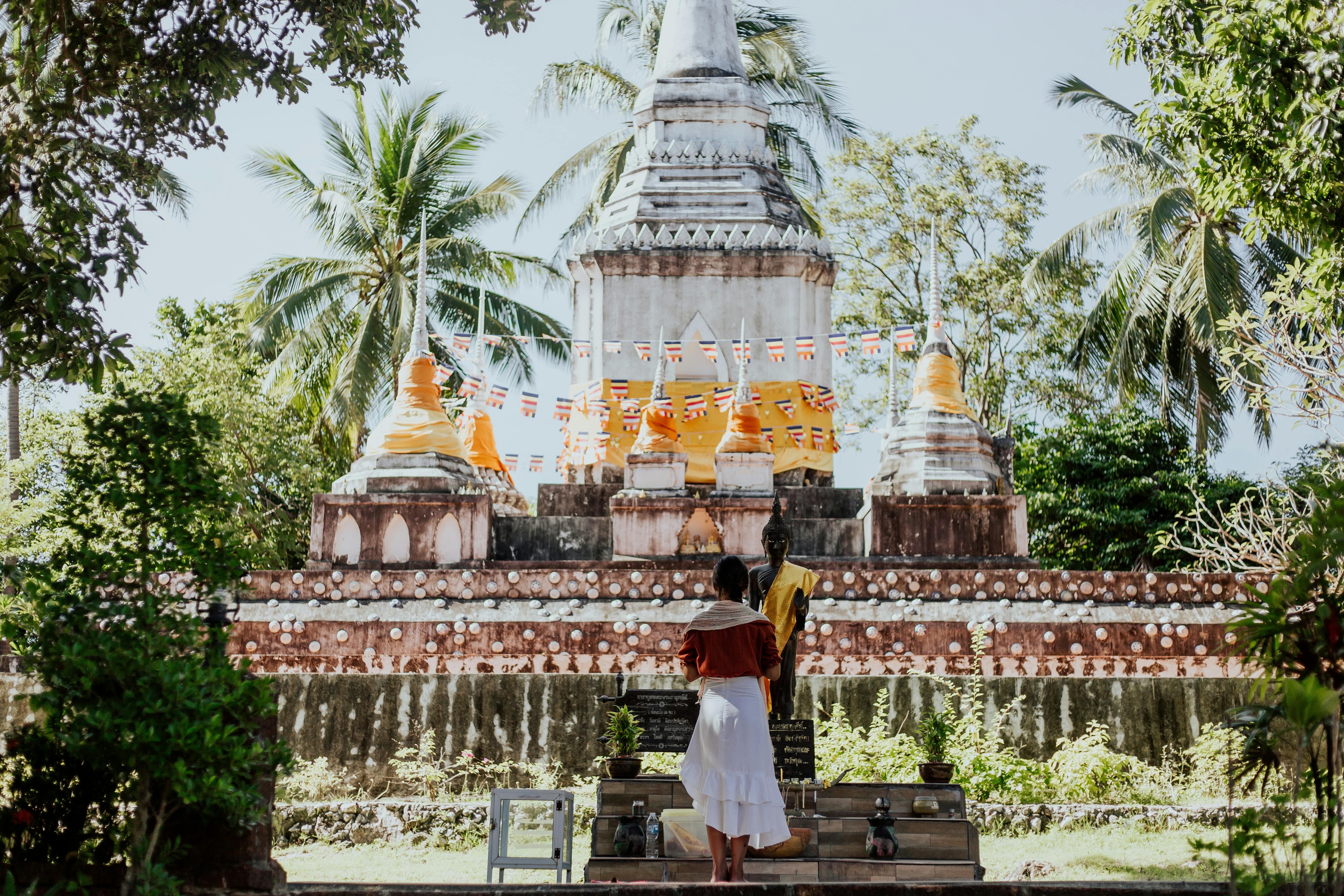 a woman praying near a temple