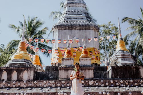 Woman Praying Outside a Buddhist Temple