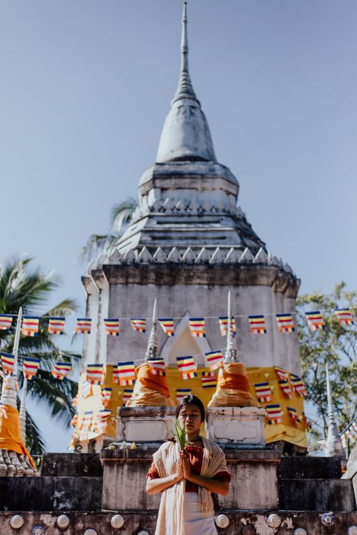 Free A serene scene of a woman meditating in front of a Buddhist temple in Varanasi, India. Stock Photo