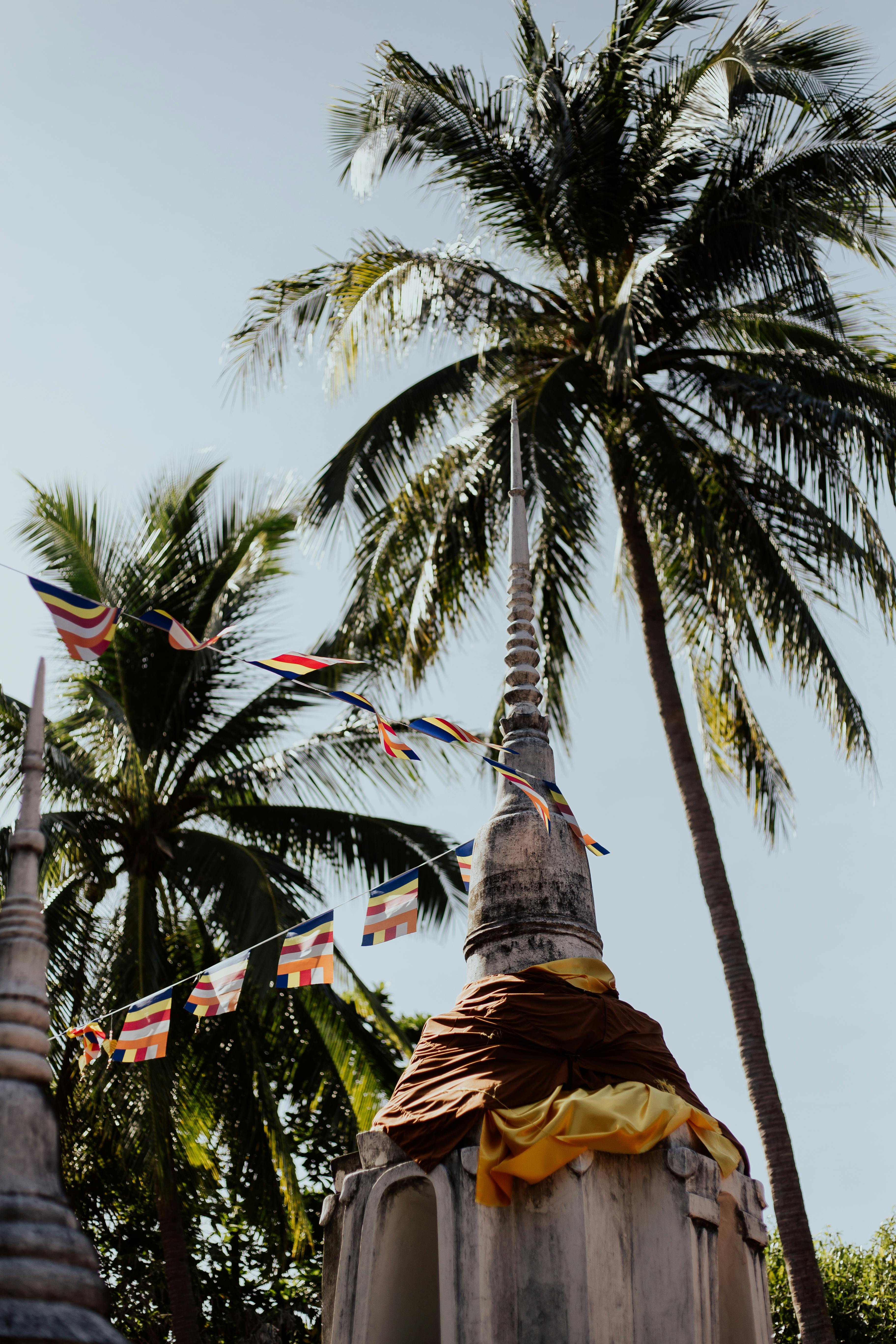 Spire of the Wat Thai Sarnath Temple with colorful prayer flags, a key attraction near सारनाथ हिरण उद्यान, वाराणसी, भारत