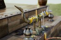 Brass Steel Bird Figurine on Brown Wooden Table