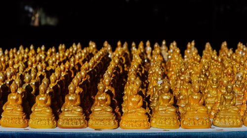 Free A collection of golden Buddha figurines arranged in rows, representing peace and spirituality. Stock Photo