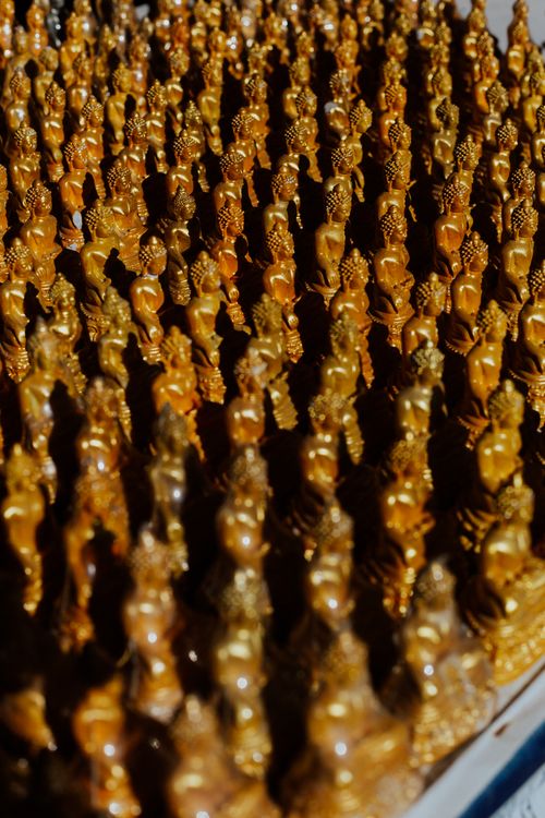 Free Golden Buddha figurines create an abstract pattern with spiritual and artistic appeal. Stock Photo