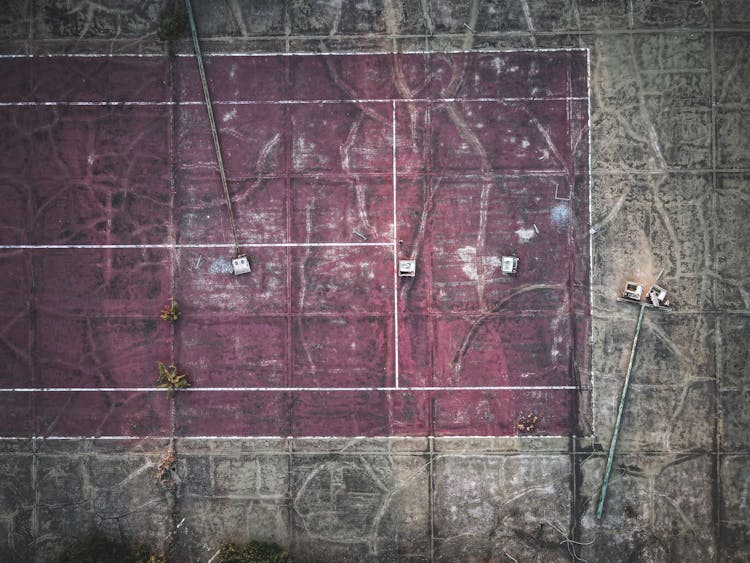 Old Weathered Sports Court In Field