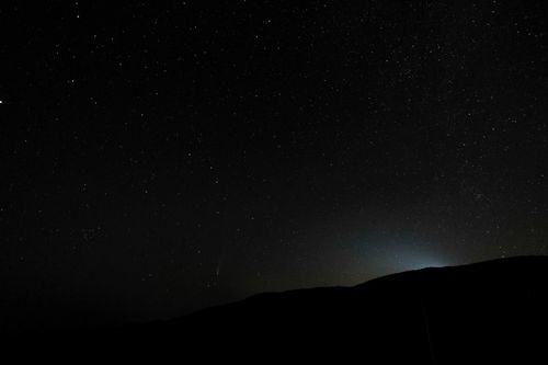 Free From below silhouette of mountain against dark night sky with shining stars in valley Stock Photo