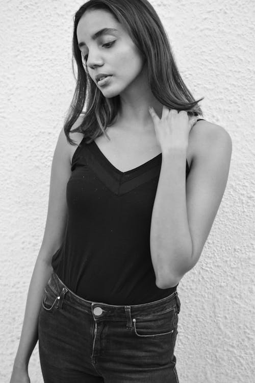 Grayscale Photo of a Young Woman in a Black Top