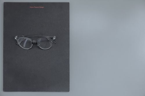 Free Clear eyeglasses on a black surface, perfect for fashion and design themes. Stock Photo